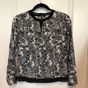 Women’s elegant black and white blouse top.